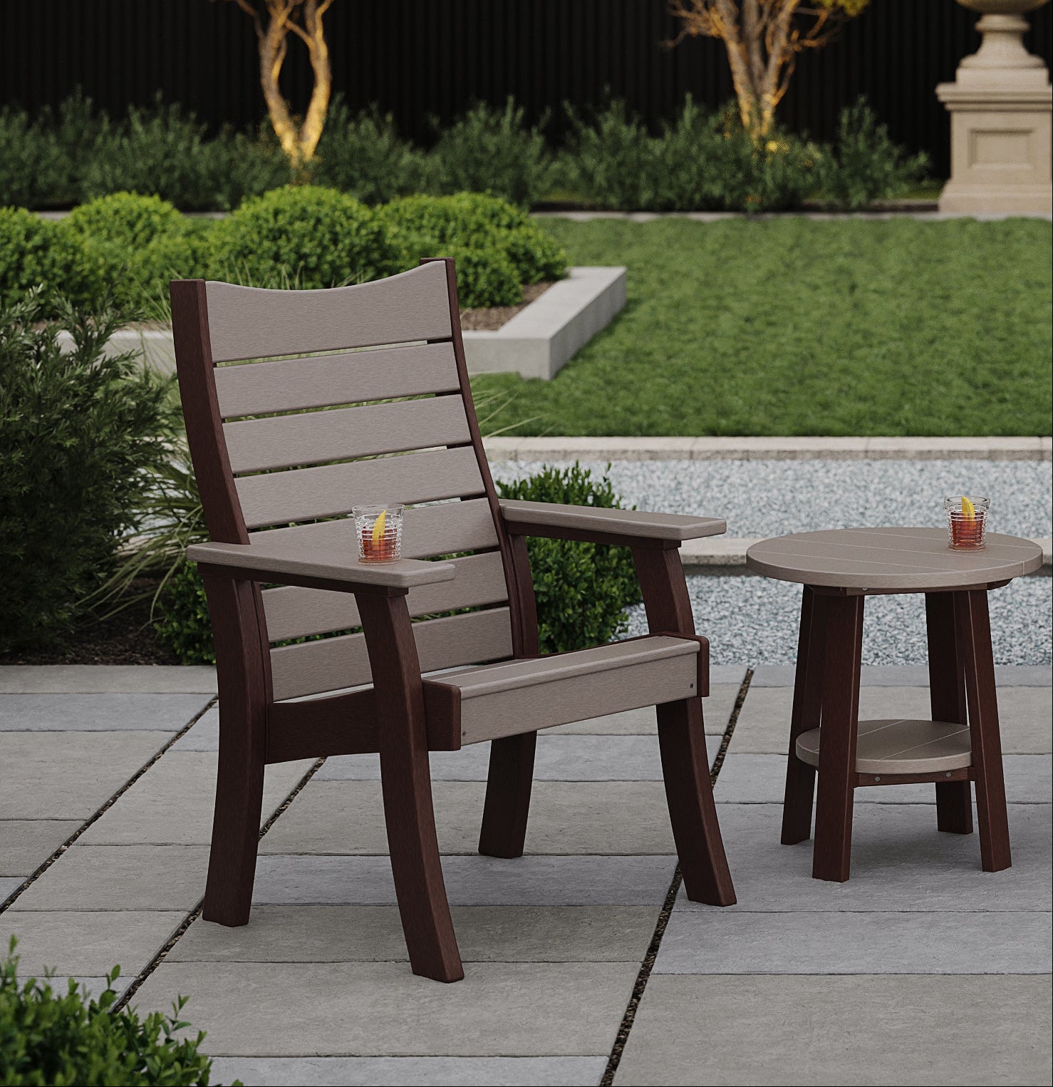 Outdoor patio set with chairs and table on a stone patio surrounded by greenery